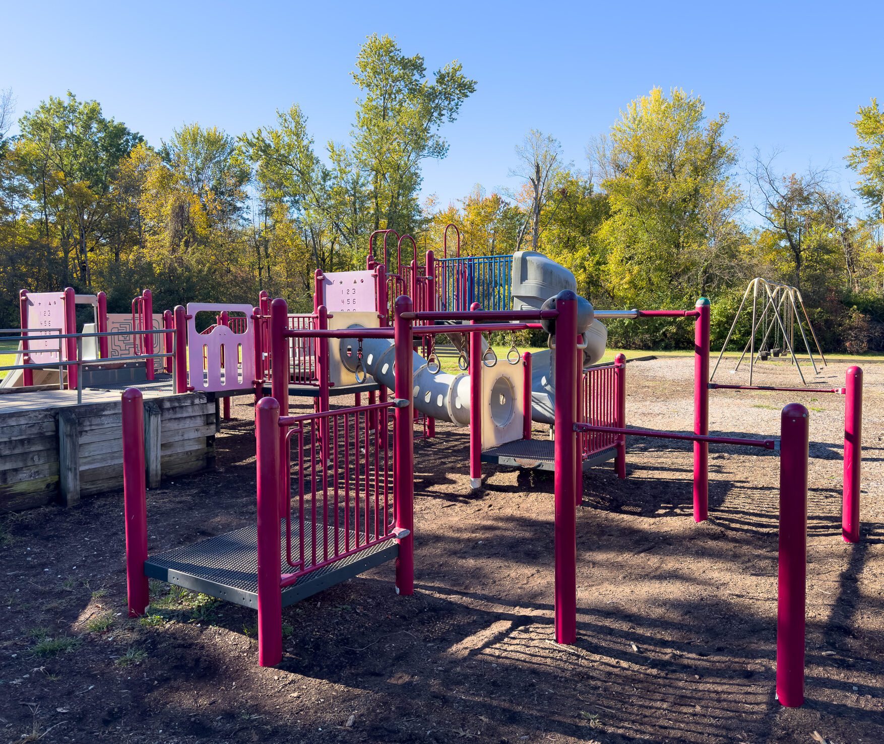 Colorful playground equipment featuring slides, climbing structures, and swings designed for children's play and outdoor activities.